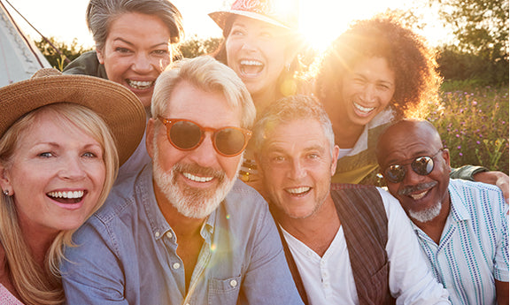 Group photo taken outdoors with participants smiling